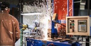 closeup image of sparks flying at a blue machine