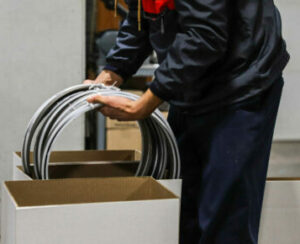 man putting saw blades into white boxes