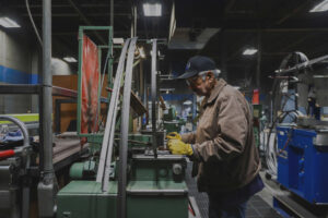man standing at a green machine