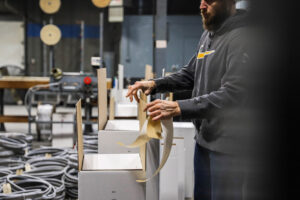 man boxing up saw blades in white boxes