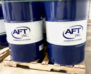 two blue AFT Inc barrels sitting on a wooden pallet