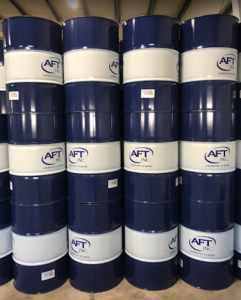 stacked up blue AFT Inc., barrels sitting on a concrete floor