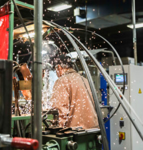 man with welding sparks flying around him